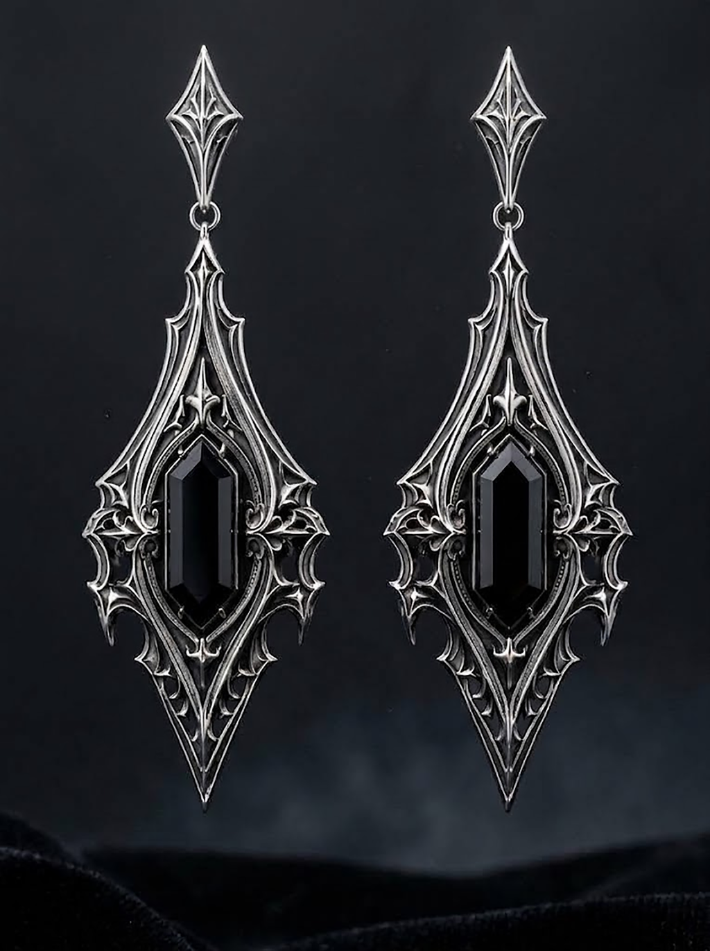 kurgaatelier pair of gothic cathedral drop earrings with elongated hexagon black gemstones floating against moody dark backdrop