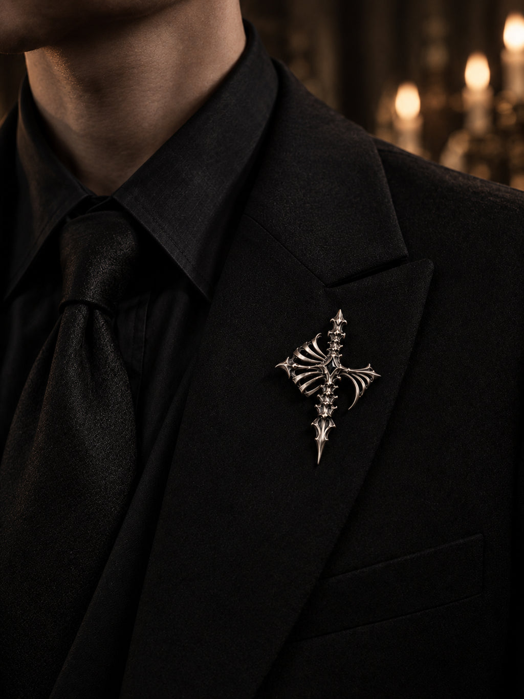 Gothic cathedral skeleton cross lapel pin in 925 sterling silver styled on a black men's tailored suit jacket by Kurga Atelier for dark academia aesthetic and gothic formalwear.