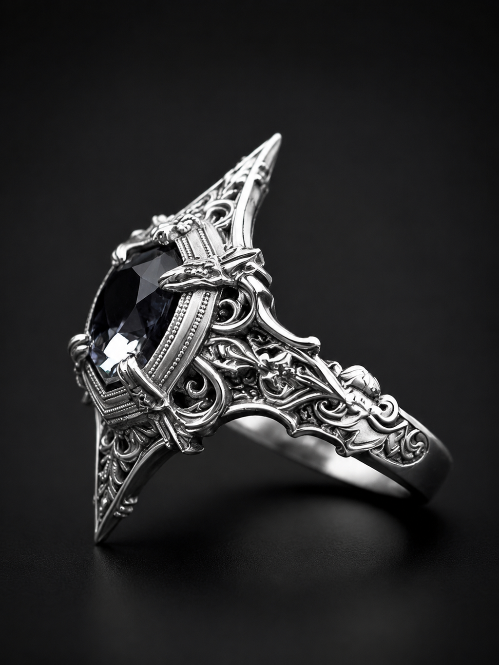 Detailed side profile view of Kurga Atelier gothic cathedral ring. Intricate oxidized sterling silver architecture filigree band holding a unique black gemstone setting.