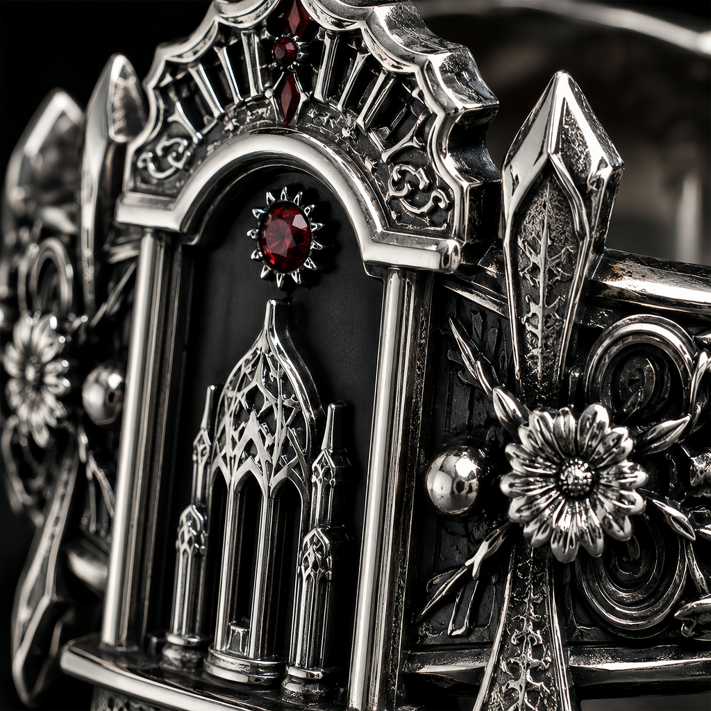 Detailed macro view of silver reliquary ring showcasing hand-carved floral motifs, oxidized vintage finish, and red gem.