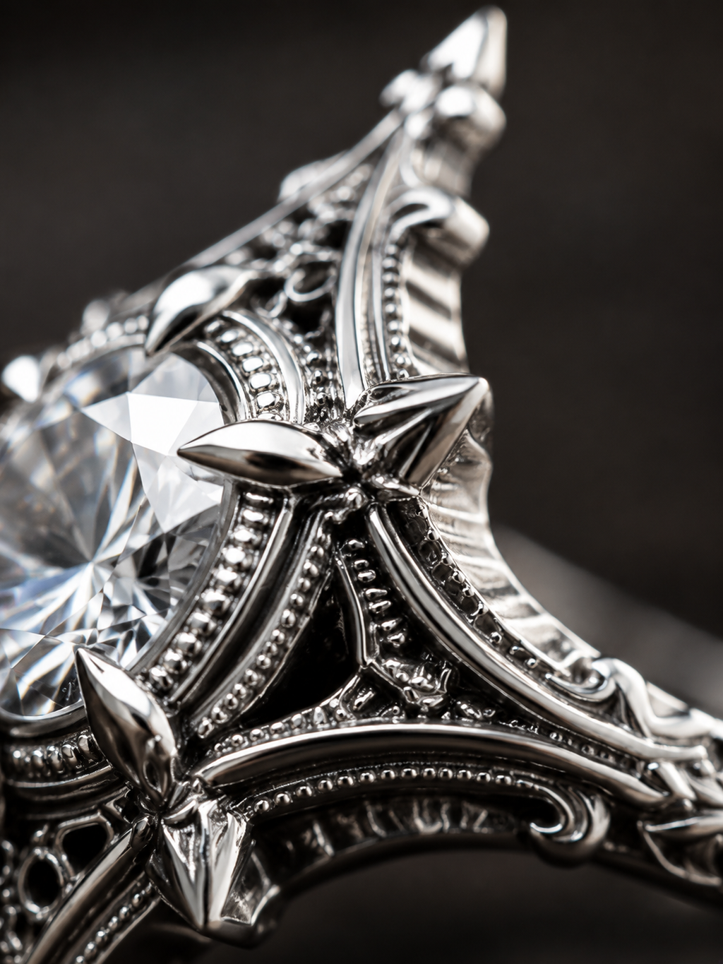 Close-up detail of gothic silver ring showing oxidized milgrain edge, filigree cutout carving, cathedral spires, and prong set round moissanite gem.