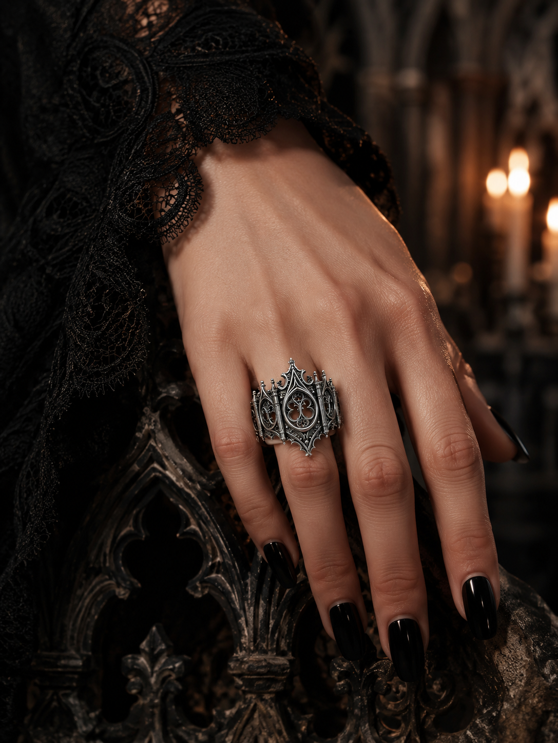 A hand with black nail polish wearing the Kurga Atelier gothic cathedral arch ring in oxidized silver, dark academia style aesthetic jewelry.