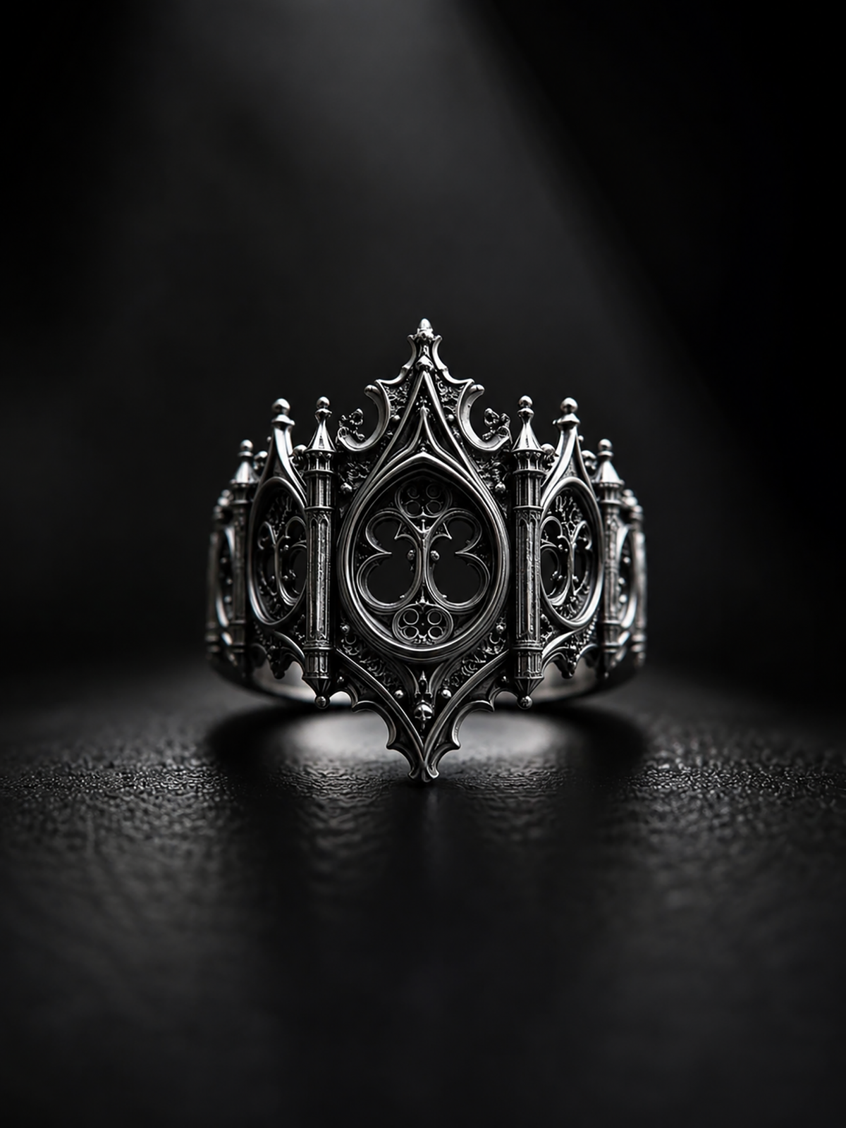 Front angle view of Kurga Atelier gothic cathedral silver band on a clean dark surface, unique alternative engagement ring for women and men.
