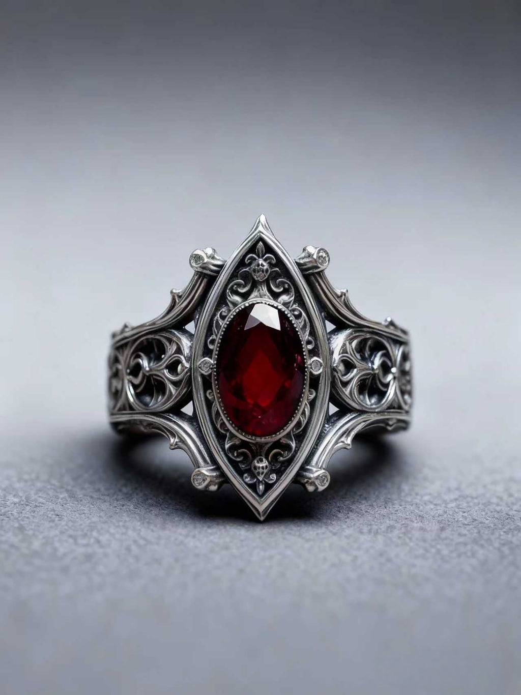 Front-facing product shot of the Kurga Atelier dark romance gothic ring against a minimalist neutral background, emphasizing its symmetrical micro-architecture.