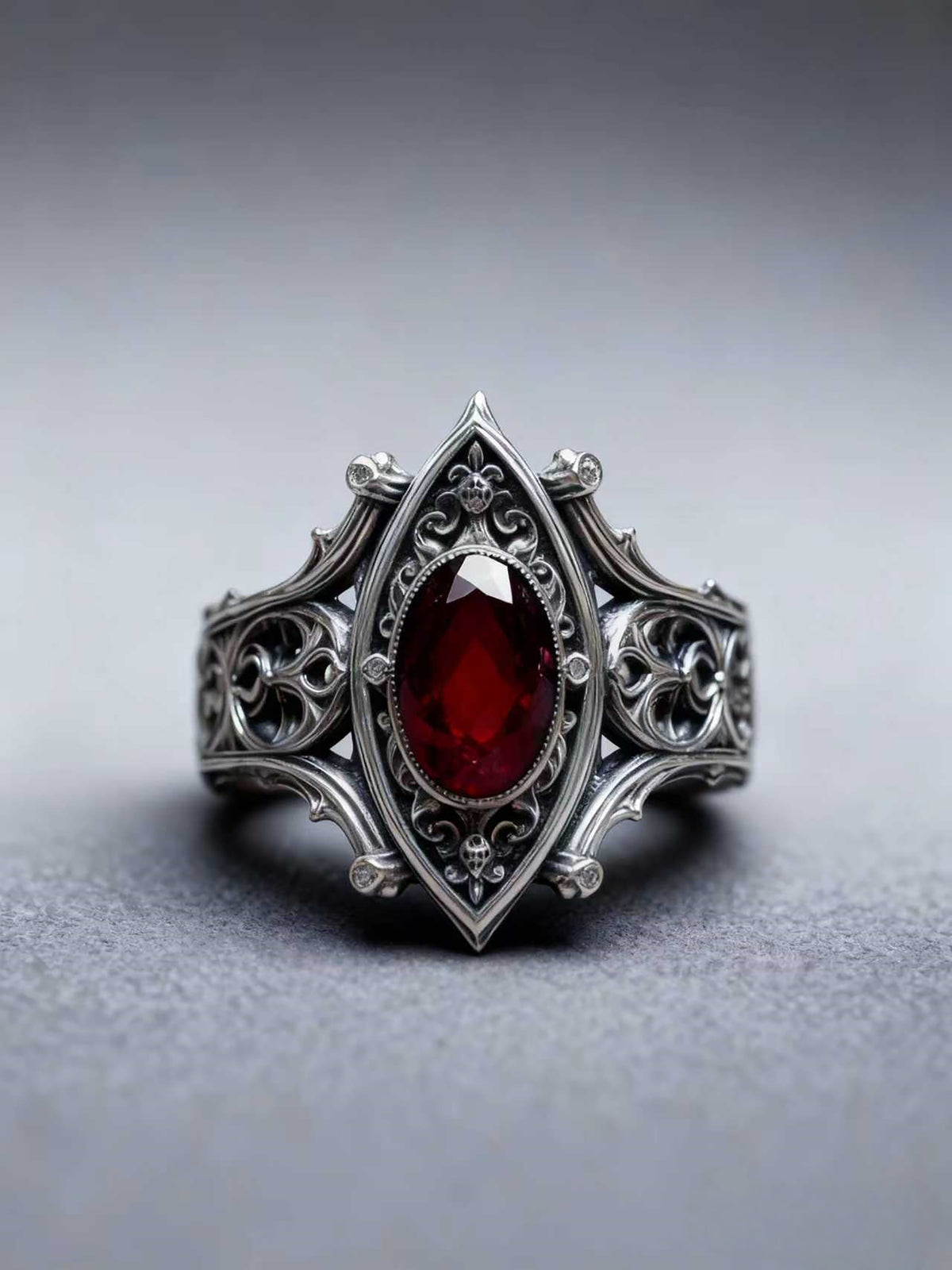 Kurga Atelier Gothic Ruby Sterling Silver Ring solo, grey background highlights vintage carvings.