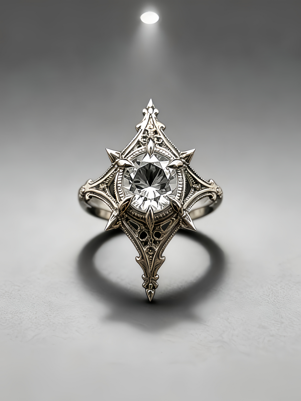 Top-down frontal view of a gothic moissanite ring with rhombus shaped setting, filigree carved band, and dark academia alternative wedding style on grey background.