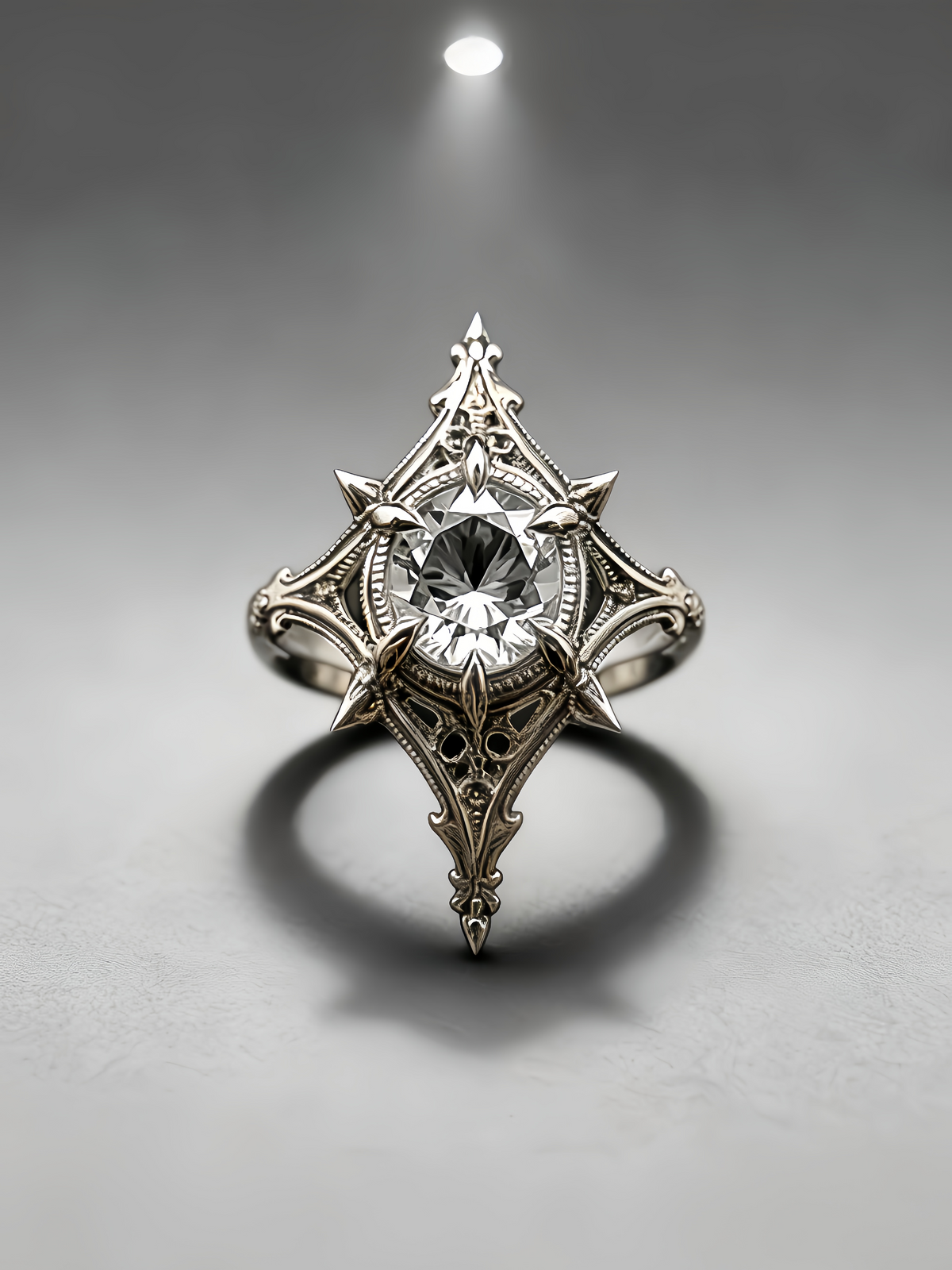 Top-down frontal view of a gothic moissanite ring with rhombus shaped setting, filigree carved band, and dark academia alternative wedding style on grey background.