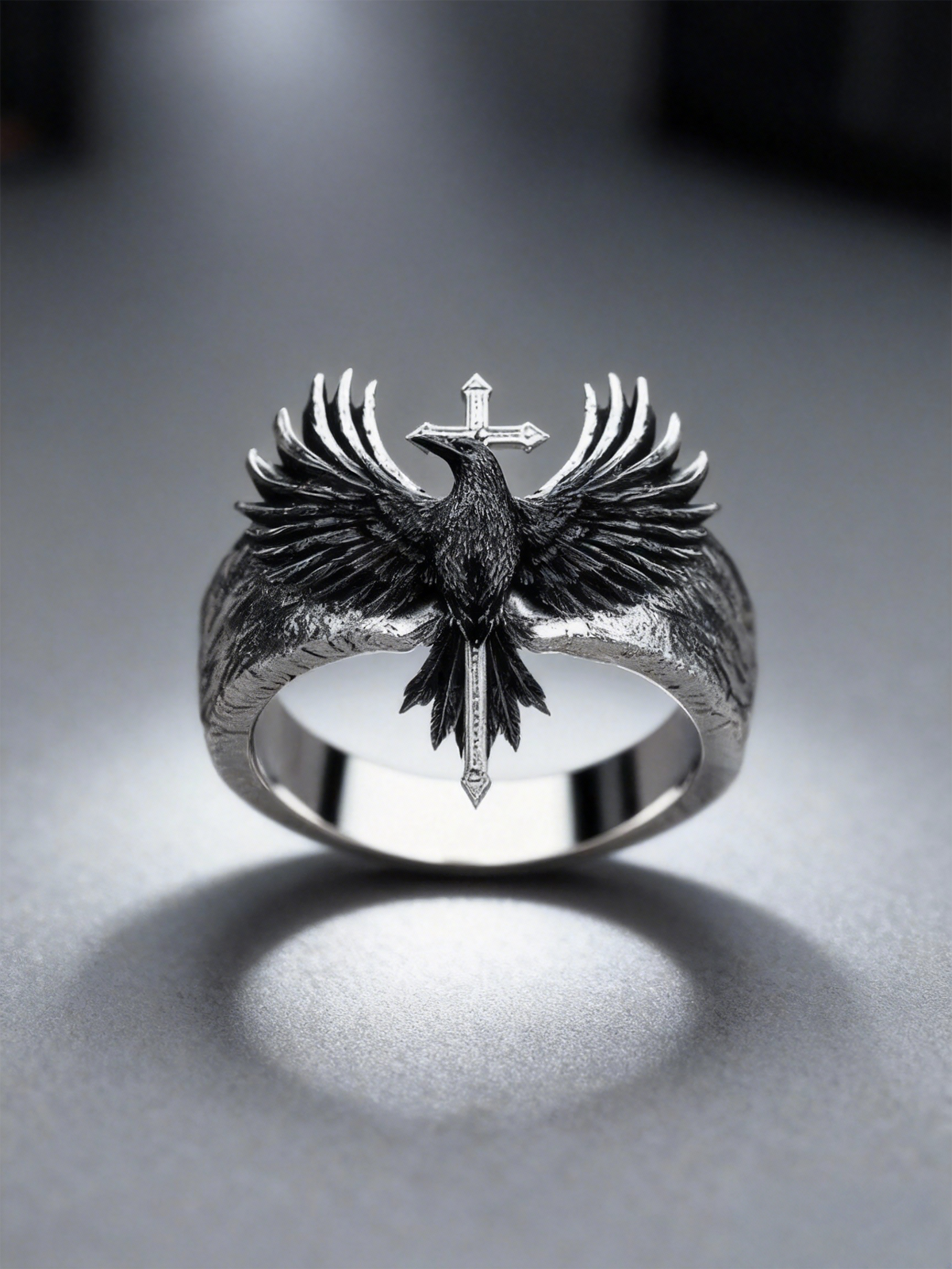 Solid 925 sterling silver gothic raven cross ring by Kurga Atelier with hand-carved wing details, oxidized black recesses, and a vertical crucifix.