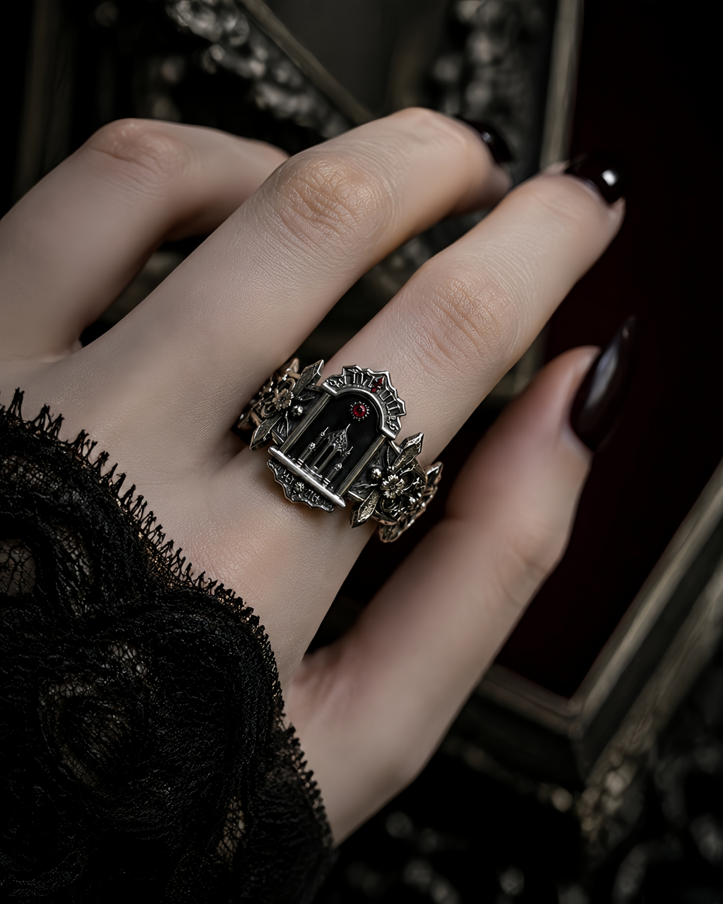 Model wearing a gothic architecture statement ring on hand styled with dark academia black lace sleeve.