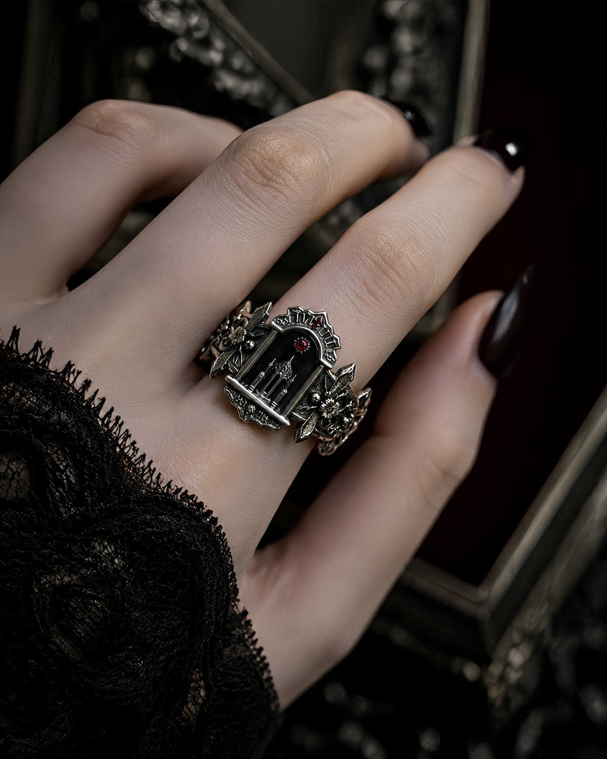 Model wearing a gothic architecture statement ring on hand styled with dark academia black lace sleeve.