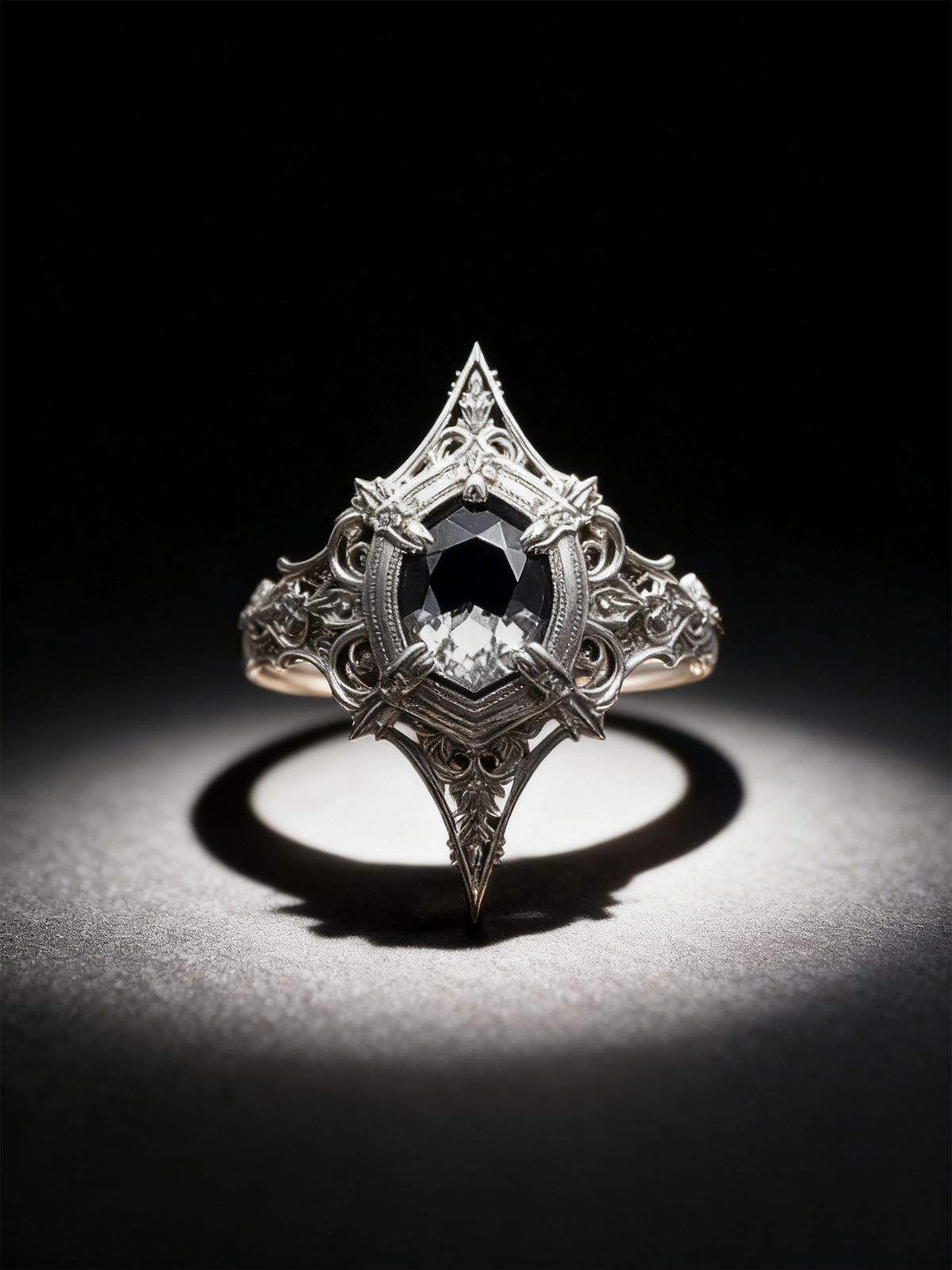 Frontal studio view of Kurga Atelier gothic engagement ring. Cushion kite cut black gemstone in an architectural cathedral shield setting on dark background.