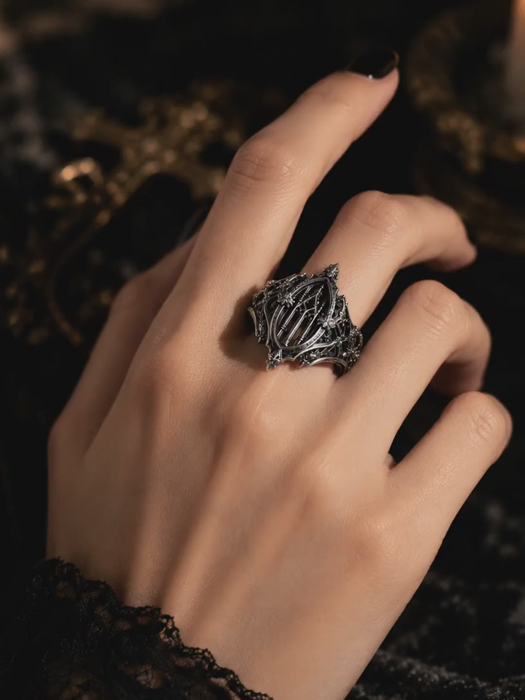 Video showing a women's witchy gothic cathedral ring by Kurga Atelier. Detailed oxidized silver church window structure with intricate bee relief sculpting for dark academia aesthetic.