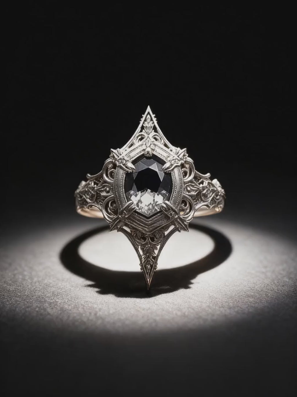 Video showcase of Kurga Atelier gothic cathedral ring. Detailed 360 view of the intricate sterling silver filigree and kite cut black gemstone ring under spotlight.