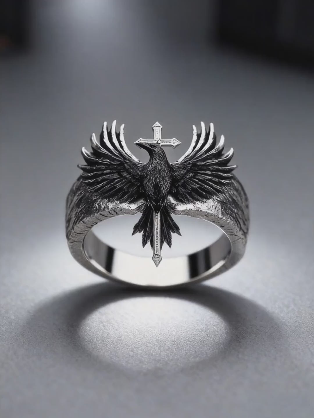 360-degree dynamic video showcase of the Kurga Atelier heavy silver raven cross ring, highlighting tactile feather carved textures and metallic reflections.
