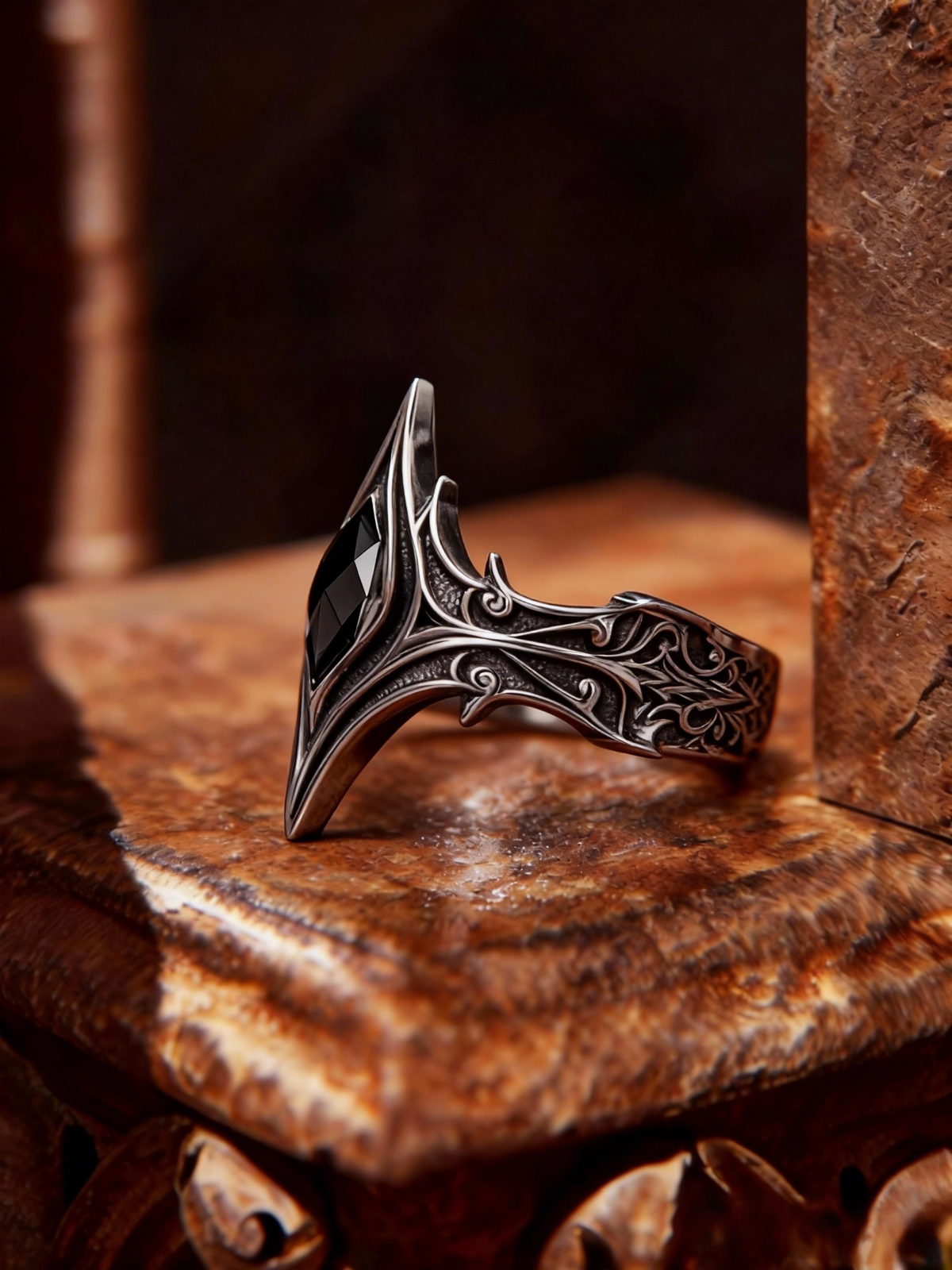 Side profile view of gothic cathedral spire ring on vintage stone pedestal, highlighting intricate arch details and oxidized silver finish by Kurga Atelier.