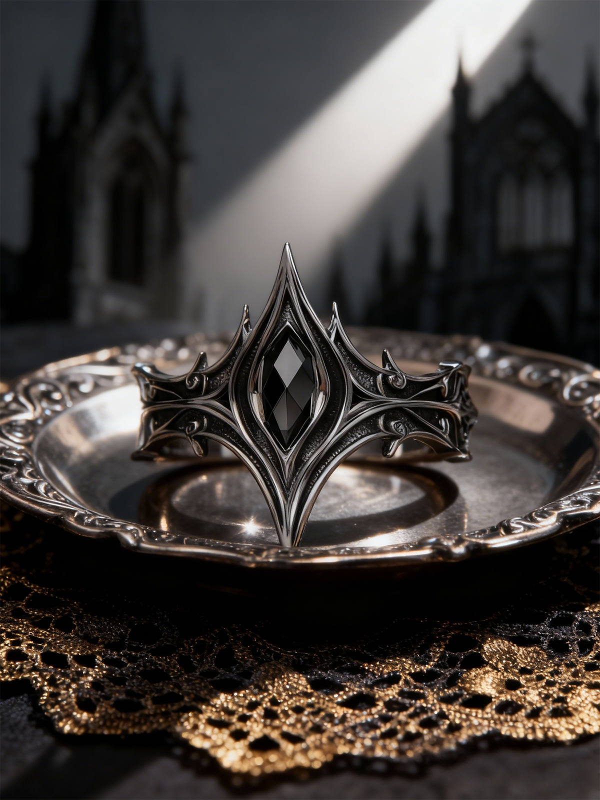Cathedral spire alternative engagement ring set on a vintage silver plate with gold lace background, dark academia jewelry handcrafted by Kurga Atelier.